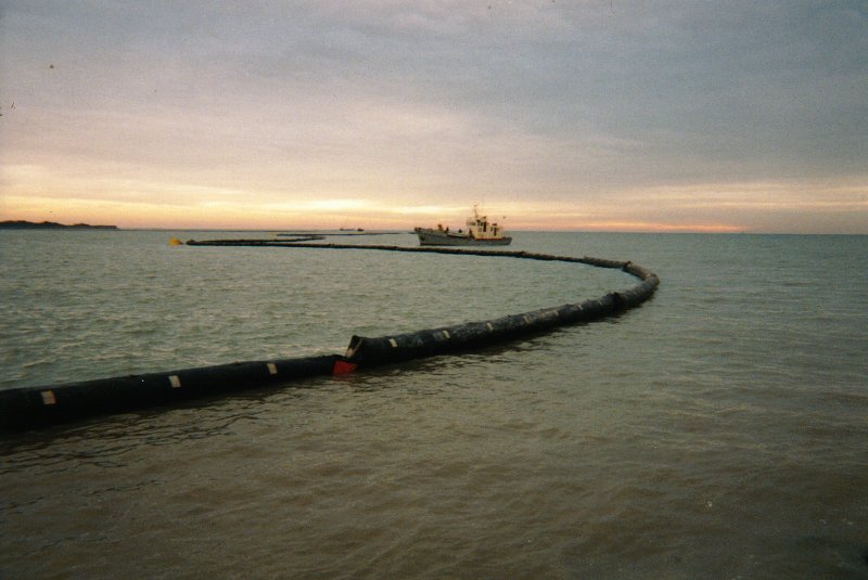 A L'entrée du port de La Rochelle,
le barrage en cours de montage,
le baliseur Estrées sur zone.